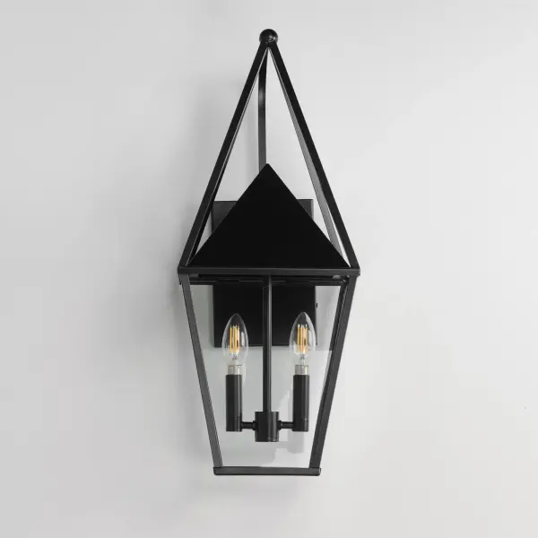 An exaggerated openwork framed steeple adds vertical qualities on a sharp-lined Matte Black lantern frame. Blending modern concepts with forms that evoke a whimsical imagery, this collection presents a transitional styling for outdoor spaces. - alternate view