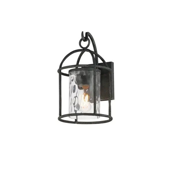 Inspired by classic European lanterns and handcrafted ironwork, the Del Mar collection brings timeless sophistication to exterior spaces. Its airy open-frame silhouette is crafted of hammered iron, elegantly arched with a graceful hook detail that nods to historic gas lamps. Inside the frame, a delicate Water glass cylinder shimmers with texture, diffusing light in a soft, atmospheric glow. Designed for lasting beauty in the elements, each piece is finished in a richly layered Blacksmith finish--a deep near-black tone highlighted by silvery brushstrokes, adding artisanal character to the silhouette. Whether flanking a grand entry or lining a garden path, Del Mar offers a refined approach to outdoor lighting with enduring presence.