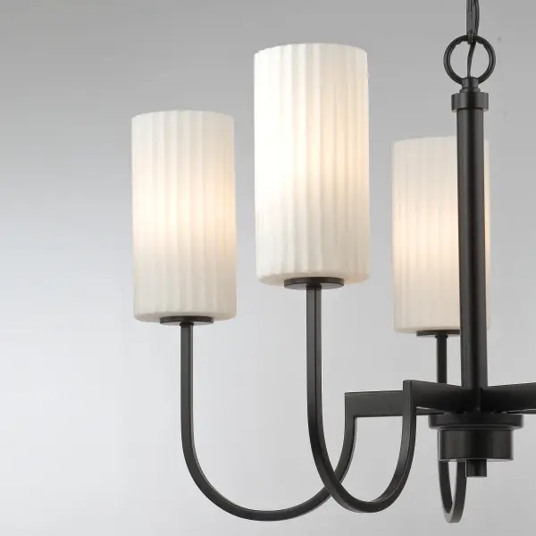 Whether in town or countryside, this collection of chandeliers simplifies the classic curved frame with a modern approach. Finished in your choice of Satin Brass or Matte Black, the sharply curved arms extend higher than classic proportions and support ribbed cylinders of opal white glass shades. These Satin White glasses upgrade pleated shades by form of their ribbed details. Available in two sizes of chandelier and a linear 4-light pendant, this collection finds its place at home in a variety of applications and fits in regardless of whether its town or country. - alternate view