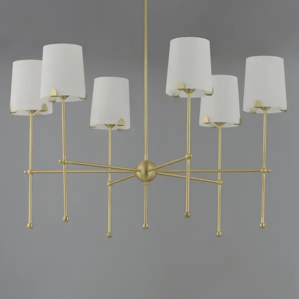 Satin White shades taper in a classic fabric shade shape and rest on elegantly thin frames of Satin Brass or Satin Nickel. They are supported secured by a mostly concealed structure with coordinating semicircular tabs that complement the spherical joints of the frame. The modern design details and updated shade materials refresh the outlook of a timeless chandelier though its use of thoughtful features. - alternate view