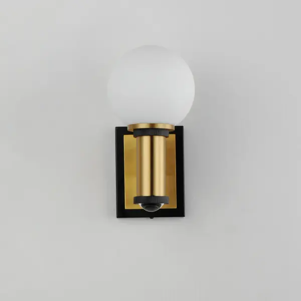 Inspired by the seaside California home that once belonged to a turn-of-the-century celebrity tycoon, the San Simeon flush mount and wall sconce embrace vintage charms using Satin White globes fastened to modernized columns with stepped details in Black and Aged Brass. The collection is also damp rated and safe for use in covered exterior spaces to add a touch of Hollywood Regency styling to your outdoor space. - alternate view