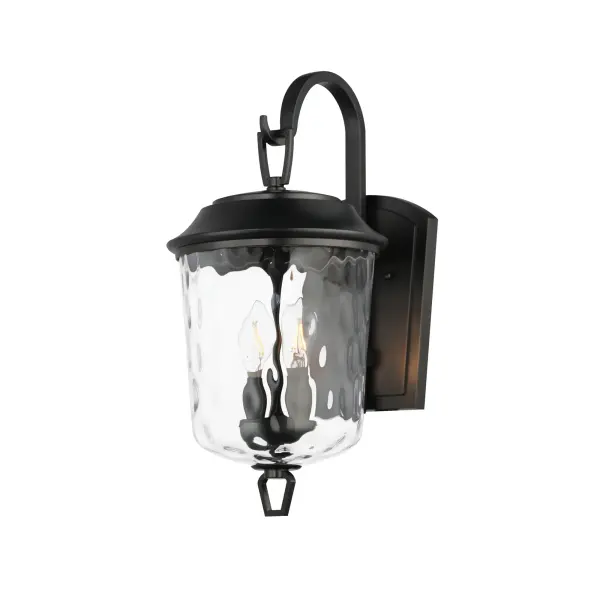 The Prescott collection of outdoor lanterns reimagines a classic design with timeless elegance. Crafted with a durable die-cast aluminum frame and finished in a sleek Matte Black, these lanterns exude a refined, understated charm. The water glass shade creates a beautiful lighting effect as it casts dazzling patterns on its surrounding surfaces. Thoughtfully updated with simple stirrup hook details, the collection effortlessly blends tradition with modern sophistication.