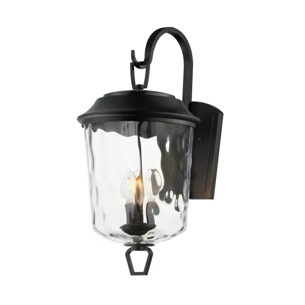 The Prescott collection of outdoor lanterns reimagines a classic design with timeless elegance. Crafted with a durable die-cast aluminum frame and finished in a sleek Matte Black, these lanterns exude a refined, understated charm. The water glass shade creates a beautiful lighting effect as it casts dazzling patterns on its surrounding surfaces. Thoughtfully updated with simple stirrup hook details, the collection effortlessly blends tradition with modern sophistication.