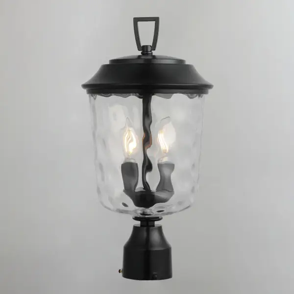 The Prescott collection of outdoor lanterns reimagines a classic design with timeless elegance. Crafted with a durable die-cast aluminum frame and finished in a sleek Matte Black, these lanterns exude a refined, understated charm. The water glass shade creates a beautiful lighting effect as it casts dazzling patterns on its surrounding surfaces. Thoughtfully updated with simple stirrup hook details, the collection effortlessly blends tradition with modern sophistication. - alternate view
