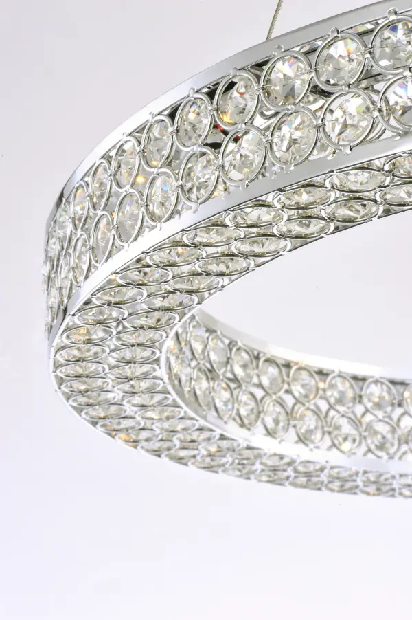 Frames of metal rings encased with Beveled Crystal Jewels, are finished in Polished Chrome. Suspended by cables as if floating In air, these rings cast rainbows of light when illuminated by the Integrated LED. - alternate view