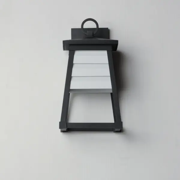 Contrasting louvered insets are set within Matte Black trapezoidal frames. The frames are made of Vivex so their finish will withstand harsher climates. The louvered panel insets are made of aluminum and feature a full cut-off design aesthetic making this design suitable for Dark Sky applications. An added benefit is the removal of glass altogether, adding a robust quality to the construction of the fixtures leading to longevity and lower maintenance. These wide plank louver panels complement the design's coastal styling adding interest in contrasting Weathered Zinc or White options, while the matte Black finish blends into the frame for a cleaner, more seamless approach. Collection: Shutters Finish: Black Glass: White Width: 7.50" Height: 14.00" Weight: 2.97 lb Extension from Wall: 8.25" Wire: 8" Canopy: 6.75"x4.75" Number of Bulbs: 1 Maximum Wattage: 60.00 W Bulb Type: A19 Bulb Base: E26 Medium Light Source: Incandescent Voltage: 120.00 V Material: EPMM, Aluminum Safety Listing: cETLus Safety Rating: Wet Dark Sky Spec Sheet Instructions - alternate view