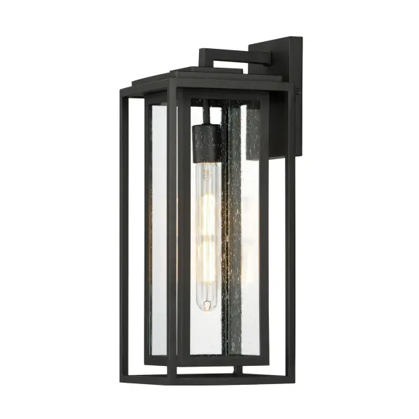 A dual framed structure creates dimension on these outdoor lighting fixtures that is both contemporary and transitional. The construction consists of two frames of square tubing and squared components. The inner frame's Clear Seedy glass reduces glare from the light and appears dirt-free for longer periods. This is a comprehensive collection to brighten all areas of your outdoor space, available in various sized sconces as well as hanging and post configurations.