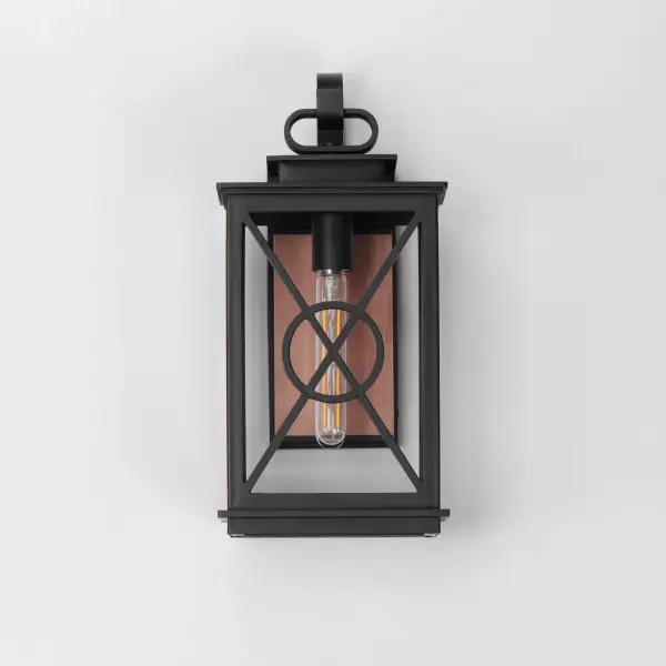 Styled as a classic early American coach lantern, the Yorktown sconces offer an established exterior design aesthetic with the modern engineering to withstand the harshest climates. A crossing pattern of the material wraps clear glass panes that protects them and adds visual interest. Featured prominently on the back plate of these lanterns is a stainless-steel overlay in Antique Copper that evokes the historical reference embodied in the design and attractive contrast to the fixtures rated for wet locations. - alternate view