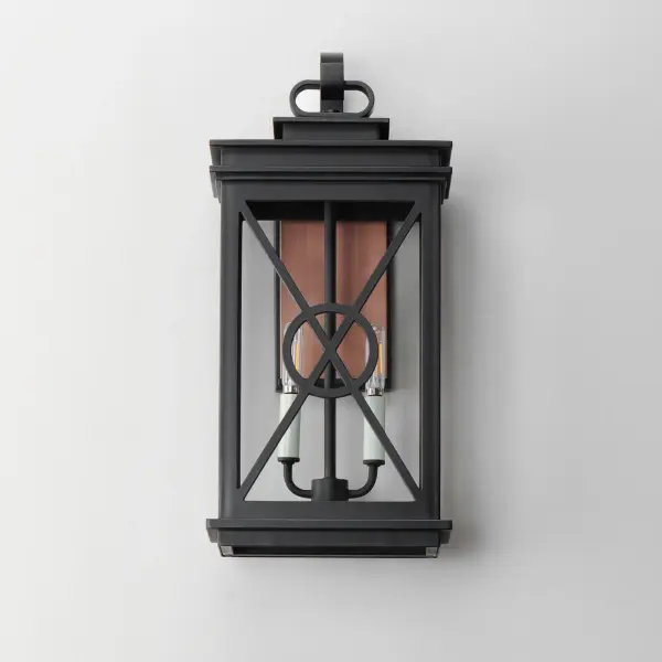 Styled as a classic early American coach lantern, the Yorktown sconces offer an established exterior design aesthetic with the modern engineering to withstand the harshest climates. A crossing pattern of the material wraps clear glass panes that protects them and adds visual interest. Featured prominently on the back plate of these lanterns is a stainless-steel overlay in Antique Copper that evokes the historical reference embodied in the design and attractive contrast to the fixtures rated for wet locations. - alternate view