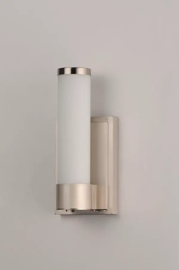 Cylinders of White cased glass are mounted onto a cast aluminum frame of Satin Nickel or Polished Chrome. LED modules evenly illuminate and provide soft yet ample illumination. Multi volt input is standard which allows for installation into commercial applications. - alternate view