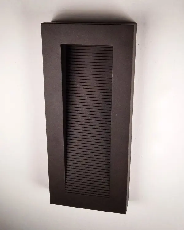 This great architectural outdoor design provides illumination from two places. A slash of light washes down the grated diffuser and out away from the wall while additional light is directed out the bottom straight down that washes the wall and illuminates the walkway below. Available In three sizes and finished in Architectural Bronze. - alternate view