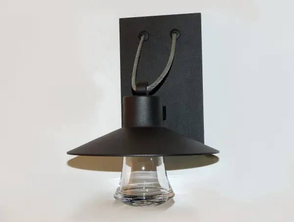 Conical shades finished in Architectural Bronze appear to be suspended by its stainless steel cable. Concealed inside these shades is a high powered COB LED which shines into a heavy Clear glass font. The bottom of theses fonts have an additional thickness of glass for better light distribution and lighting effect. - alternate view