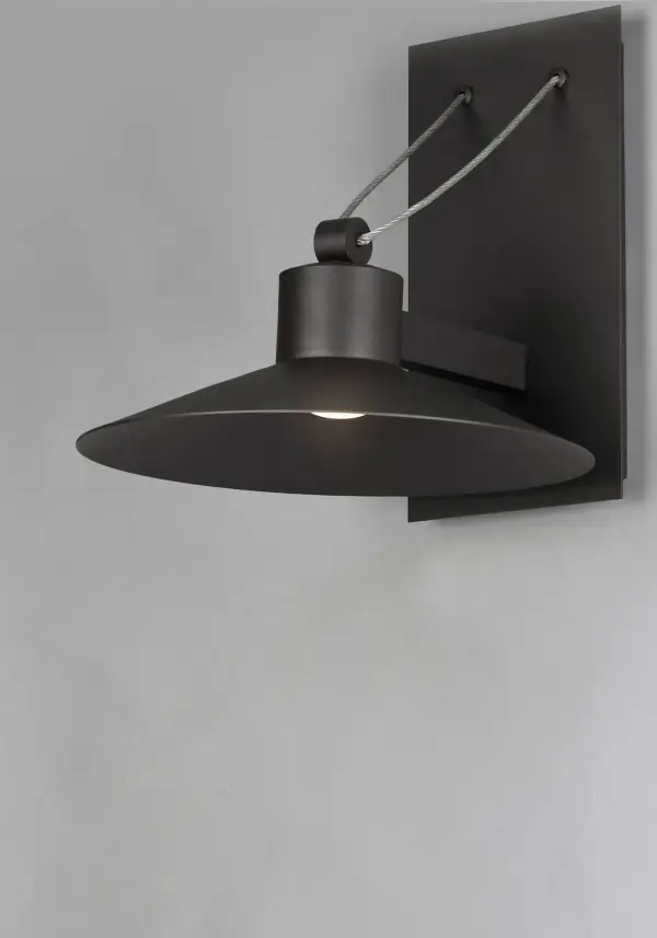 Conical shades finished in Architectural Bronze appear to be suspended by its stainless steel cable. Concealed inside these shades is a high powered COB LED which shines into a heavy Clear glass font. The bottom of theses fonts have an additional thickness of glass for better light distribution and lighting effect. - alternate view