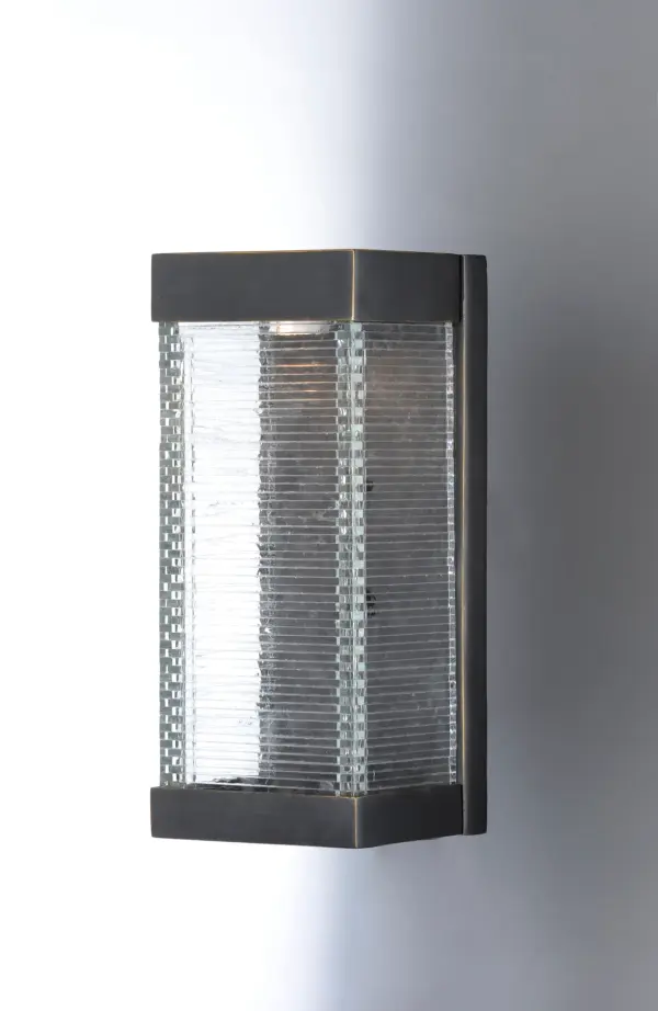 Layers of Clear panels of glass are stacked and fused to create an unusual outdoor design. Integrated LED mounted on the inner Bronze finished hood shed light down the sides of the glass creating an interesting lighting effect. - alternate view