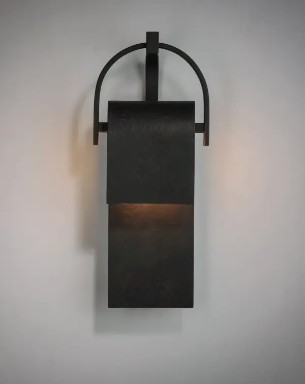 A panel of aluminum is bent forward at the top and cradled by a bracket. A beautiful textured Rustic Forged finish is used in keeping with the pastoral design elements. Cleverly concealed inside the arch is a LED light source which sheds ample light to the surface below without forward glare. - alternate view