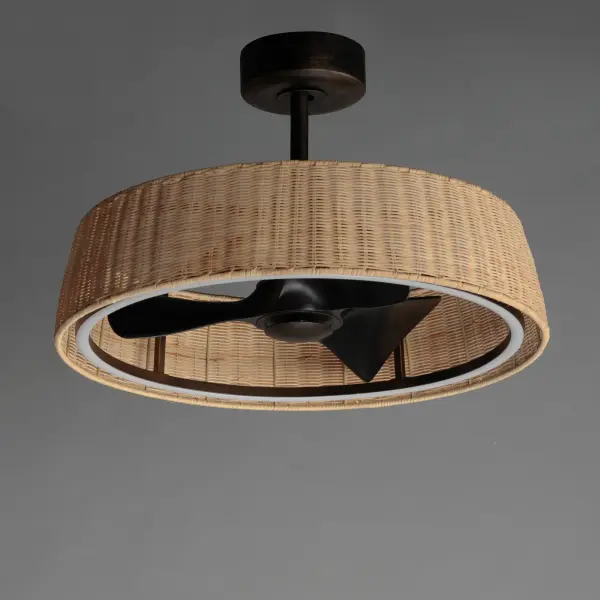 Hand-woven rattan wicker in a natural or darkened finish are shaped into a sloping drum shade with an internal fan and LED light source within them. The contrasting Dark Bronze finish of the metalwork encases an LED ring toward the bottom edge of the shade allowing for a strobe-free light effect directed downward. The surface coatings are rated for outdoor applications so the rattan and the metalwork are purposefully designed for outdoor spaces under covered roofs. Transform your patio with coastal flair and escape the heat with this Fandelight by Maxim. - alternate view