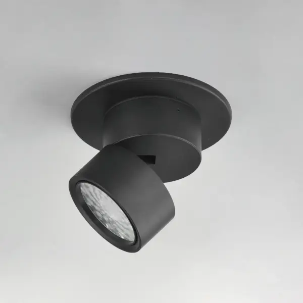 Inconspicuously recessed within its cylindrical house, an extending arm transforms this surface mounted light fixture into an adjustable spotlight. Simply unthread the top half along the seam to extend the frame length and swing the fixture into position. Twist the lens on the face of this fixture to adjust its beam angle spread. Available in Black and White and two apertures that include a mud-in ring for an even cleaner installation. - alternate view