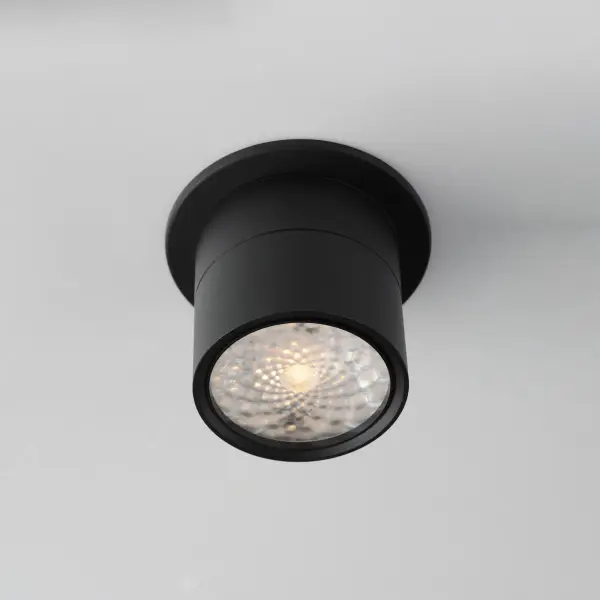Inconspicuously recessed within its cylindrical house, an extending arm transforms this surface mounted light fixture into an adjustable spotlight. Simply unthread the top half along the seam to extend the frame length and swing the fixture into position. Twist the lens on the face of this fixture to adjust its beam angle spread. Available in Black and White and two apertures that include a mud-in ring for an even cleaner installation. - alternate view
