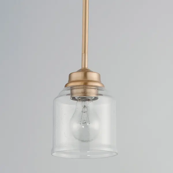 A modest frame of steel tubing gently bends to support a cluster of Clear Seedy bell-shaped glass. Similarly the bobeches and other metal accents echo that traditional bell shape creating an instant classic. An easy choice with transitional appeal, choose from a variety of complimentary finishes including matte Black, Heritage Brass or Satin Nickel. Collection: Acadia Finish: Heritage Glass: Seedy Width: 4.75" Height: 7.25" Length: 4.75" Weight: 2.43 lb Wire: 120" Canopy: 5"x5"x1" Number of Bulbs: 1 Maximum Wattage: 60.00 W Bulb Type: E26 Bulb Base: E26 Medium Light Source: Incandescent Dimmable Voltage: 120.00 V Material: Steel + Glass Safety Listing: cETLus Safety Rating: Dry Manufacturer Warranty: 1 Spec Sheet Instructions - alternate view