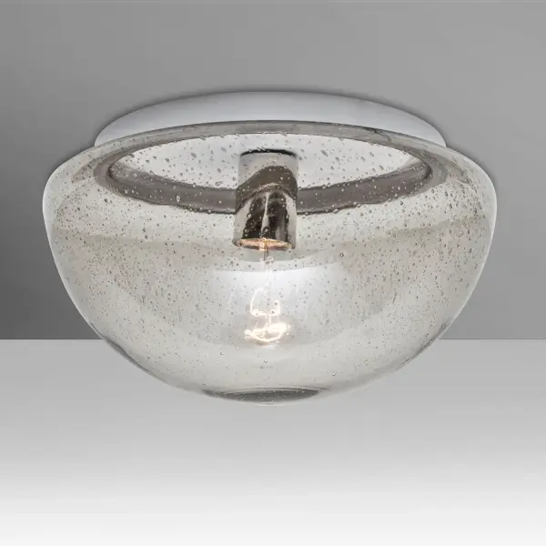 The Clear Bubble semi-flush ceiling light features transparent glass with randomly blown bubble accents that create captivating light patterns. UL wet location rated for covered ceilings, showcasing visible lamp filaments.
