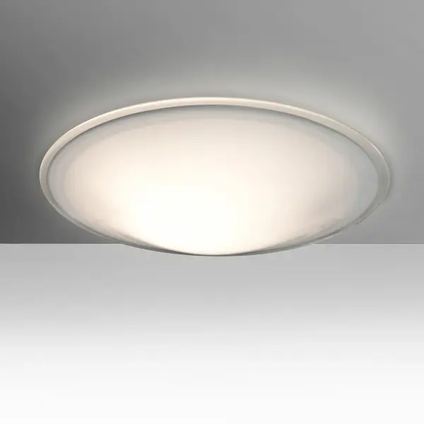 The Luma flush mount showcases hand-blown opal glass with a distinctive clear-edge halo effect. Century-old glassblowing techniques create a warm, tranquil glow perfect for intimate spaces. Easy bayonet mount installation.