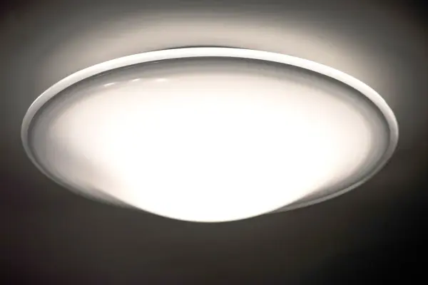 The Luma flush mount showcases hand-blown opal glass with a distinctive clear-edge halo effect. Century-old glassblowing techniques create a warm, tranquil glow perfect for intimate spaces. Easy bayonet mount installation. - alternate view