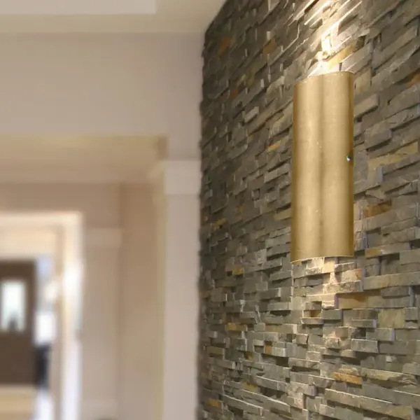 The classic colonade-shaped Torre wall sconce has minimal hardware to show off the beautiful open-ended handcrafted glass. ADA-Compliant. Our Gold Foil glass is sparkling and metallic. Distressed metal foil is applied to the inner surface of a glossy clear blown glass. This décor is full of textured and depth, however the outer surface of the glass is smooth. When lit the glass comes to life, as the distressed foil allows glimpses of light to pass through. This blown glass is handcrafted by a skilled artisan, utilizing century-old techniques passed down from generation to generation. Each piece of this décor has its own artistic nature that can be individually appreciated. - alternate view