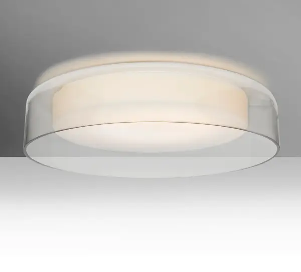 The Tango is a distinctive double-glass flush mount, crafted with an inner opal cylinder centered within a transparent outer glass. The clear blown glass is contemporary yet timeless, and will suit any classic or modern decor. When lit, the clear glass shimmers and sparkles with the accents from the light source. This blown glass combination is handcrafted by a skilled artisan, utilizing century-old techniques passed down from generation to generation.