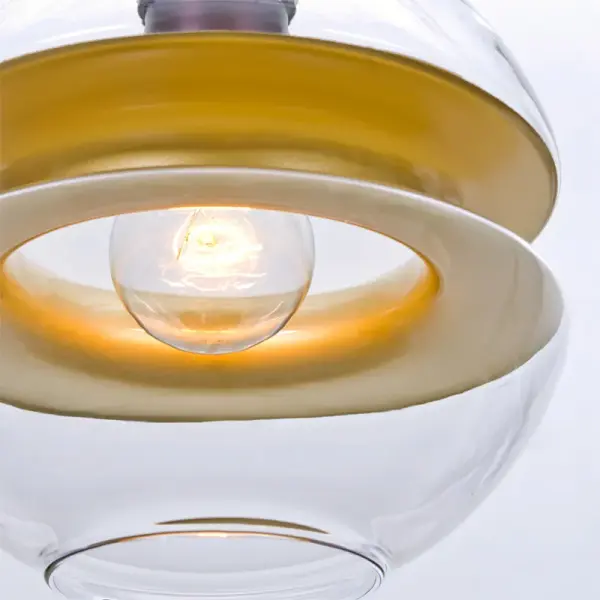 The Hula 8 Pendant combines clear glass with a striking gold band, offering a sophisticated look that bridges traditional and modern design. Its semi-concealing shade provides ambient lighting while the clear glass creates a beautiful peripheral shimmer. - alternate view