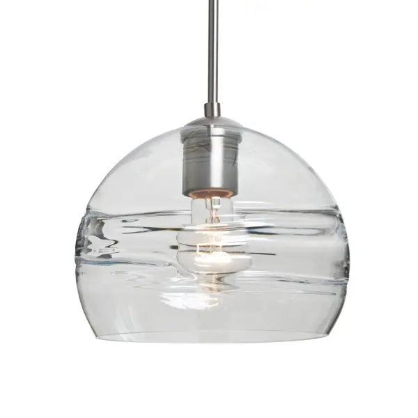 The Spirit 8 Clear Pendant features a distinctive circular optical pattern blown into the interior wall, creating dramatic light play and visual interest. The clear glass showcases the lamp filament while the sculpted layer projects beautiful patterns onto surrounding surfaces.