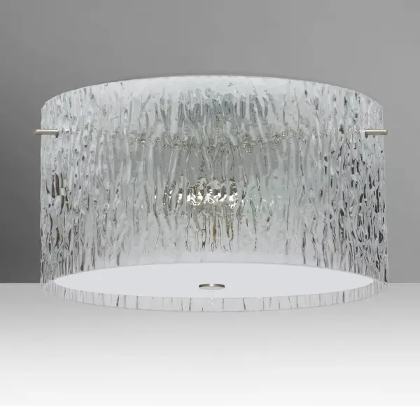 The Tamburo Clear Stone combines artisan glassblowing techniques with a unique sandstone-textured surface that mimics natural ice formations. This semi-flush mount offers ambient lighting through handcrafted glass in a timeless cylinder shape.