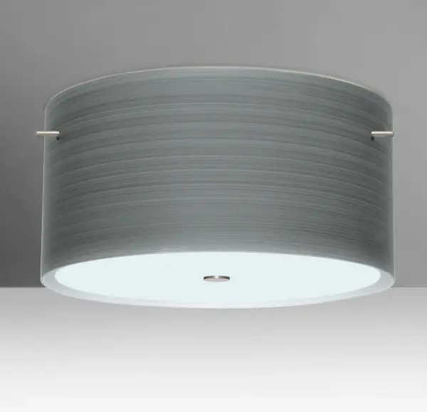 The Tamburo Titan features handcrafted off-white cased glass with spiraling silver strokes and etched satin finish. Century-old glassblowing techniques create a textured surface that transforms when illuminated, revealing intricate brushwork patterns.
