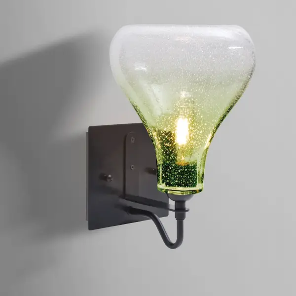 The Melo Sconce combines classical glass shaping with modern bubble detailing for a striking visual effect. Its gooseneck design and transparent shade beautifully showcase lamp filaments while the random bubble pattern creates captivating light play.