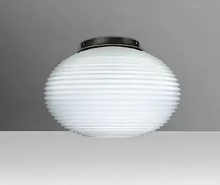 The Pape semi-flush mount features handcrafted glass with distinctive ridges and a compact profile, making it ideal for contemporary spaces with lower ceilings or smaller rooms requiring elegant ambient lighting.