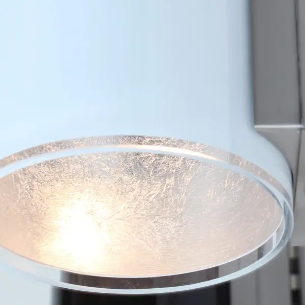 The Pogo Wall vanity light features handcrafted white blown glass with distressed silver foil interior, creating a brilliant metallic glow. Century-old glassmaking techniques meet contemporary design in this versatile fixture. - alternate view