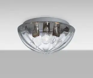 The Pinta flush mount combines clean contemporary styling with an innovative optical glass pattern that creates visual interest around exposed filament bulbs. Its 15-inch diameter provides ample illumination while maintaining a low 7-inch profile perfect for standard ceiling heights.