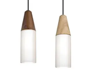 The Nini Natural Pendant combines handturned ash wood with clear glass for a warm, organic aesthetic. Its compact 3.75" diameter makes it perfect for intimate spaces or clustered installations over islands and dining areas.