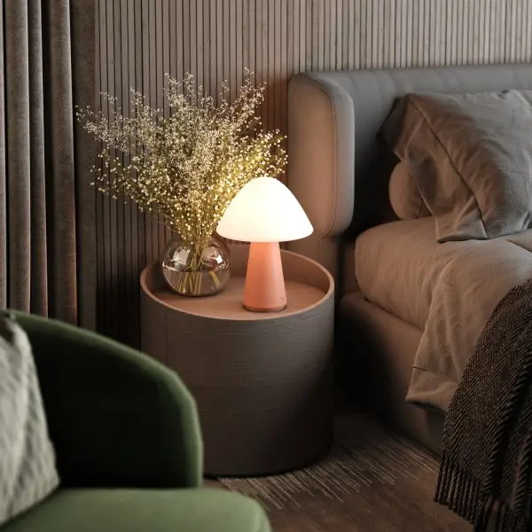 The Mushroom lamp reimagines iconic 1960s design with contemporary cordless technology. Its two-layer opal glass shade creates a mesmerizing glow, while the cast concrete base adds artistic stability. With 8+ hours of battery life and three brightness levels, this portable accent piece offers ultimate placement flexibility indoors or out. - alternate view