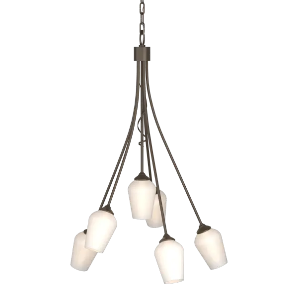 Taking inspiration from nature, our artisans fashion our six-armed Flora chandelier at our forge in Vermont. A single tendril peeks down between the light stems, giving a teasing hint of a verdant bloom soon to arrive.
