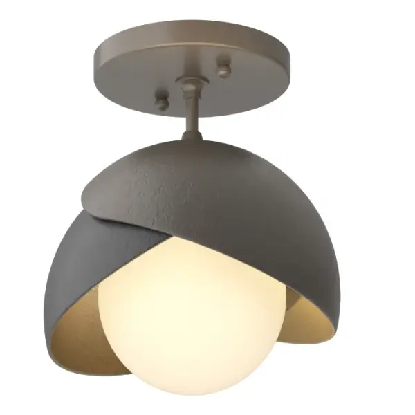 The Brooklyn Double Shade Semi-Flush brings a bit of whimsy to its space. Some see it as "botanical" with cupping leaves, others see it as a bit of a "wink", the Brooklyn lights up its space. With the option of a two-toned finish, with a choice of accent color for one of the forged and textured shades, this ceiling fixture offers functional yet stylish light. Available in all standard finishes. - alternate view