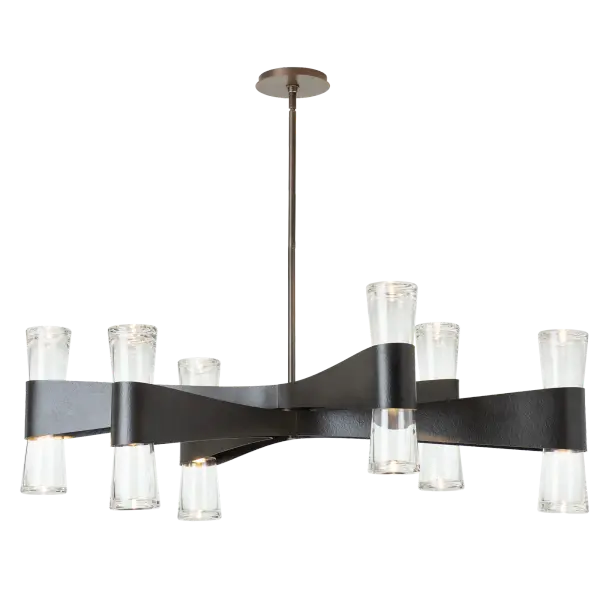 Artisanal forging on display, this grand Bellis chandelier gives an oval shape with its outstretched arms. Stunning, classic with a transitional style, the Bellis is a showstopper. Each of the six arms holds a duo of light. Up- and downlights are contained within crystal clear, thick, slightly flared glass. Available in any of our standard interior finishes.
