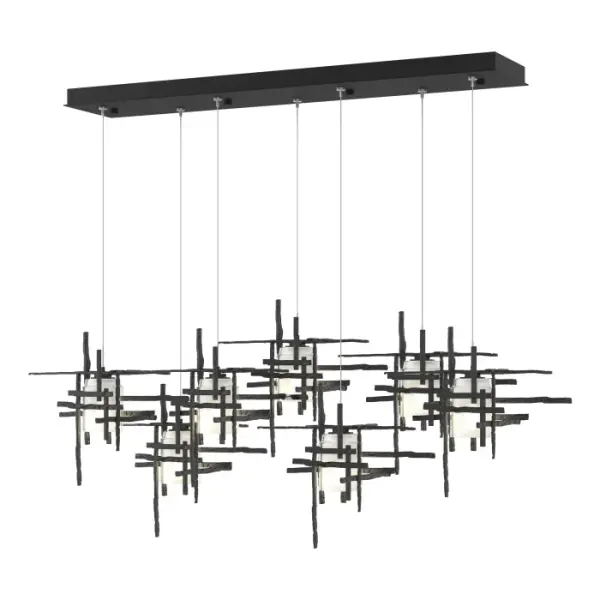 This 7-Light Tura with its rectangular canopy is a linear multi-port pendant, with both depth and dimension. Each intersecting piece is crafted from from annealed aluminum that are hand textured using a trip hammer and custom dies. This Tura Pendant's shades are made of simple, thick cylinders of frosted glass. Available in all standard finishes.