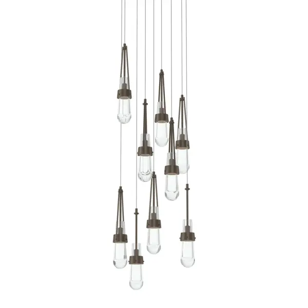 The popular Link Collection expands to include new multi-port fixtures. The Link 9-Light fixture features a round canopy from which nine pieces of clear glass are in staggered suspension. A focal piece for any space, the Link cascades downward from its canopy. Metalwork is available in all standard finishes.