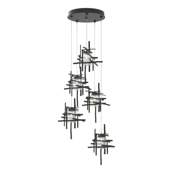 Thick, seeded clear glass shades are nestled within each of the Tura 5-Light Pendant’s modern, open, cage-like individual pendants. Perpendicular, intersecting pieces of hammered annealed aluminum, are painstakingly handmade with a trip hammer and dies by Vermont artisans. Easily customizable in length, the Tura is so versatile that you can feature it as a semi-flush or a longer pendant with cascading light with an easy cable adjustment.