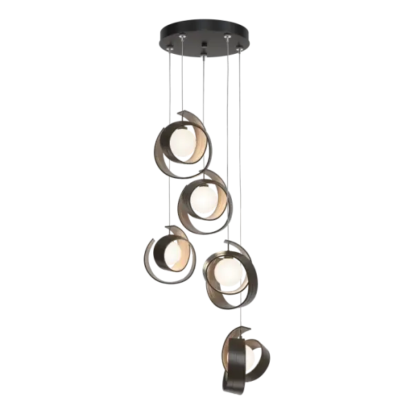 Pendant or semi-flush? The versatile Riza 5-Light can be either! Customizable cable lengths can be shortened to create a dramatic semi-flush; while longer lengths allow you to create a cascade of staggered light, gather them together at one length, or any design that suits the space. The Riza design is striking with its sculptural, modern style. The hammered texture of the shaped aluminum “curls” are handmade by our artisans in Vermont.