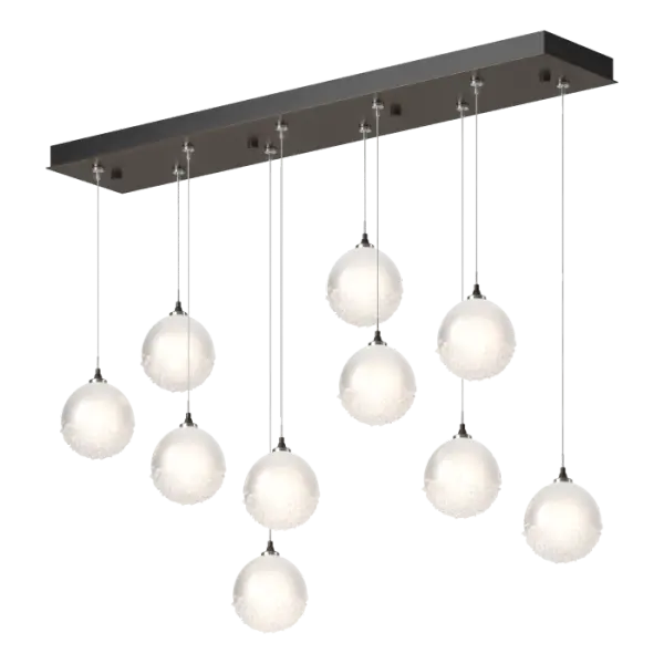 The Fritz Globe 10-Light Pendant is a stunning ceiling fixture that will add a touch of elegance to any space. The ten glass spheres are etched on the inside to provide more diffuse light, and the bottom of the outer glossy surface is covered in a heavily-textured fritted glass. This multi-port lighting fixture with its rectangular canopy allows you to customize the lengths and positions of each individual pendant, from aligned to staggered for effect.