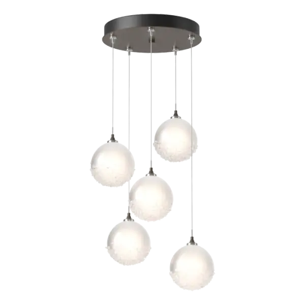 An elegant ceiling fixture, the Fritz Globe 5-Light Pendant is as versatile as it is beautiful. With its smaller round canopy and ability to customize each individual low-voltage cable length, the Fritz 5-Light can be a dramatic semi-flush or a graceful pendant—whatever suits your space! Five spherical glass shades are etched on the inside to provide a diffused light, with the bottom of each outer glossy surface, covered in a heavily-textured fritted glass.