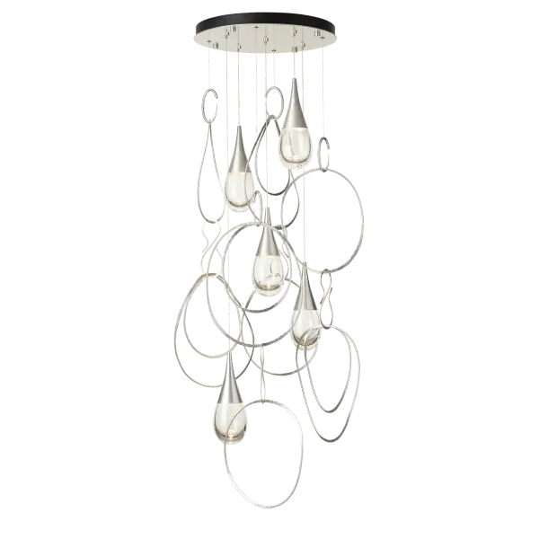Delightful movement. The Lyric 5-Light Pendant features hand-forged and hammered metal rings, jewelry-like stylized "hooks" and beautiful thick, clear teardrop shaped glass descending and capped by sleek metal forms. Aptly named, this lyrical display with metal rings that are free-moving, brings a delicate and wondrous element to any space. It's round canopy allows for a variety of configurations, from simply staggered to a cascading spiral effect. - alternate view