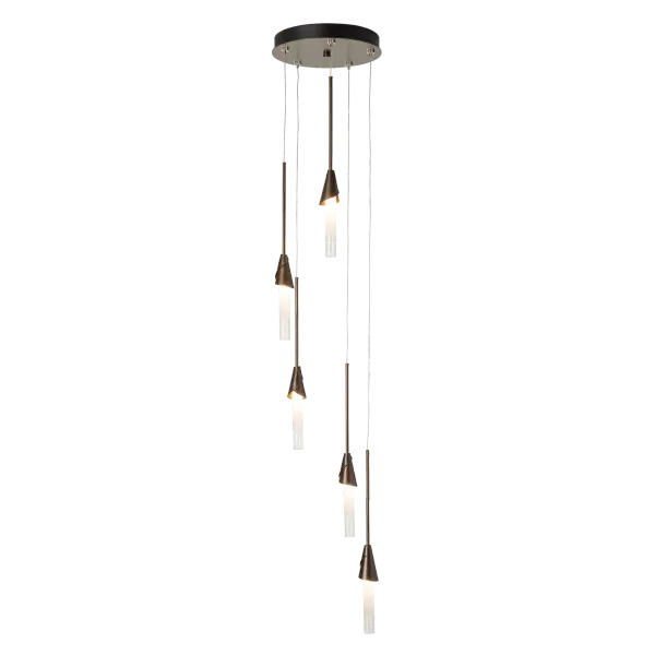 Five cascading pendants are clustered on a round multi-port canopy. Individual pendant lengths are customizable to suit the space, making this Lilium 5-Light Pendant an easy choice. With a substantial range of cable length (25-90”), this pendant can make a dramatic statement, whether in a space with lower or higher ceilings. Easy adjustability of each individual pendant length makes it simple to personalize to suit its space. Five artisanal, hand-forged "cups" embrace beautiful ombre glass cylinders. - alternate view