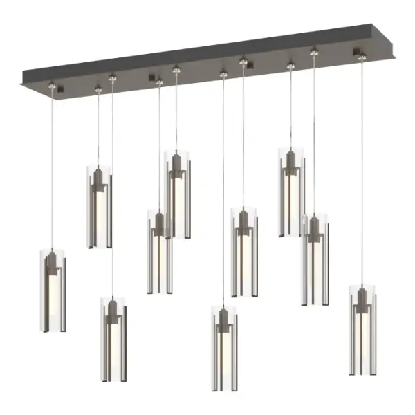 The classic Exos Collection gets a contemporary look with the festive Exos 10-Light multi-port pendant. Suspended from a rectangular canopy, ten tall glass shades are each held by three handcrafted vertical metal pieces that secure the glass within. Shades are offered in a choice of opal or clear glass. Available in any standard finish.